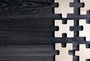 puzzle elements on a wooden background as a riddle photo