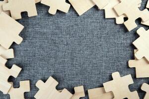 puzzle elements on a textile background as a riddle photo