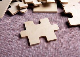 puzzle elements on a textile background as a riddle photo