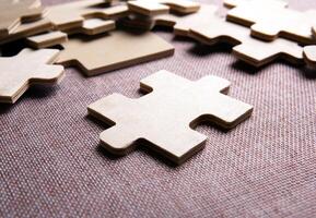 puzzle elements on a texile background as a riddle photo