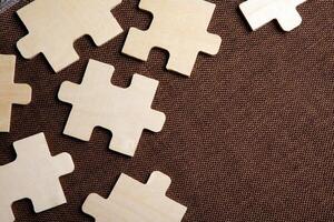 puzzle elements on a brown background as a riddle photo