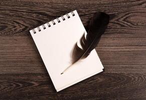 writing pen and notebook on a wooden table photo