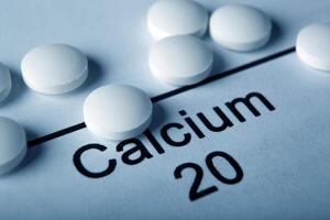 white tablets with calcium and the inscription of the chemical element Calcium photo
