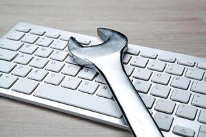 big wrench and a computer keyboard close up photo