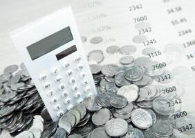 white calculator with russian ruble coins and digits photo