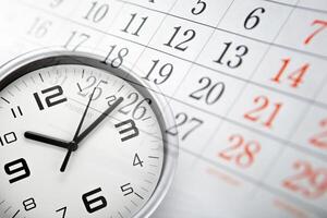 wall calendar with the number of days and white clock face photo
