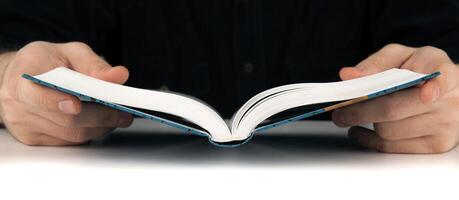 Man's hands and man looking for something in the book photo