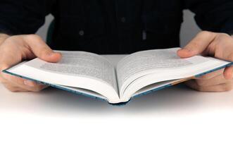 Man's hands and man looking for something in the book photo