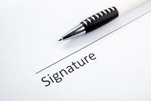 One document with a place for a signature and a pen photo