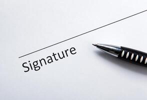 One document with a place for a signature and a pen photo