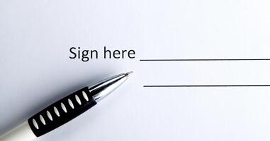 One document with a place for a signature and a pen photo