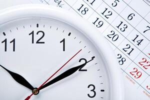 clock face and calendar sheet with numbers photo