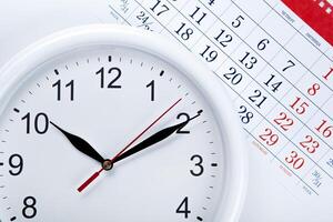 clock face and calendar sheet with numbers photo