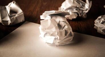 still life of paper and a crumpled paper on a table photo