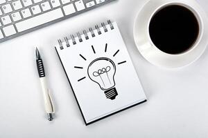 business still life of a notebook with an icon of idea and keyboard on the desktop photo