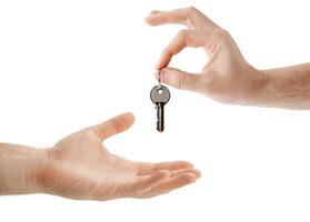 hands over the keys to the apartment from hand to hand photo
