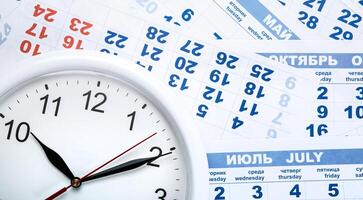 clock with wall calendar sheets with the number of days photo