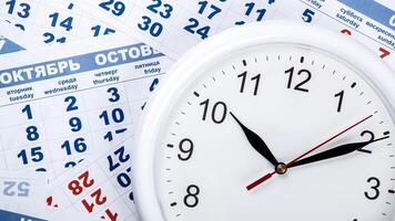 clock with wall calendar sheets with the number of days photo