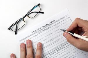 human hand and the form of the document application for employment photo