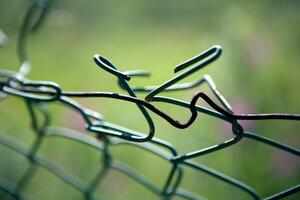 broken mesh fence as a symbol of defencelessness photo
