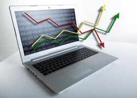 working at a laptop analytics forecasting calculations photo