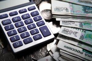 money in the form of banknotes and coins with calculator photo