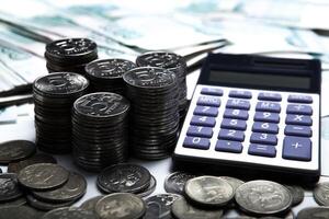 money in the form of banknotes and coins with calculator photo