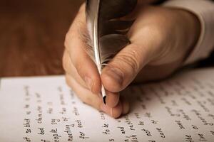 writer writes a fountain pen on paper work photo