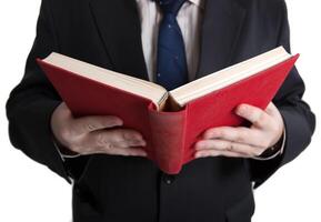 man holding an open red book photo