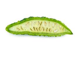 slices of bitter gourd arranged on white background photo