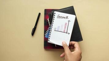 Hand holding a notebook with a graph on it video