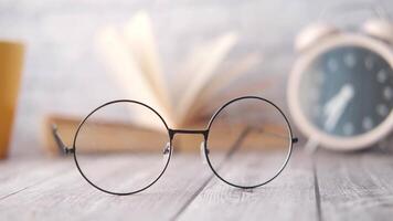 Glasses on a table with an alarm clock video