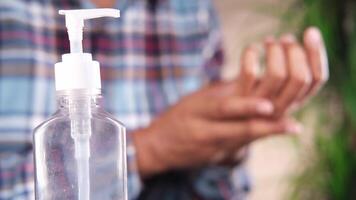A man is holding a bottle of hand sanitizer video