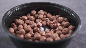 A bowl of chocolate covered cereal sitting on a table video