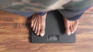 A person standing on a digital scale video