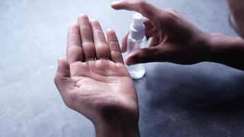 close up of young man hand using hand sanitizer spray. video