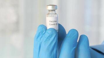 A person holding a vial of the vaccine video