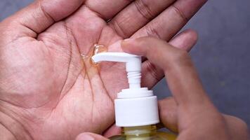 A person is using a hand sanitizer to clean their hands video