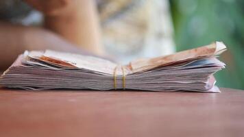 A Stack of Currency Notes Neatly Arranged on a Wooden Table, Representing Wealth video