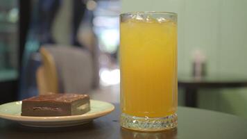 A Refreshing Citrus Drink Accompanied by a Decadent Chocolate Dessert on a Relaxing Table Setting video