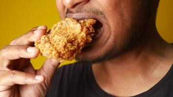Man enjoying fried chicken, mouth open, savoring every bite with a big smile video