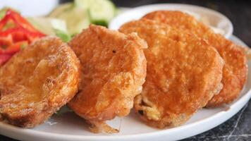 Deliciously Crispy Fried Snacks Accompanied by an Array of Fresh and Colorful Vegetables video