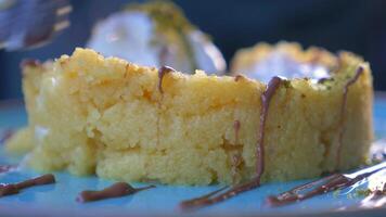 Enjoy a Delicious Slice of Moist Cake, complemented perfectly with Ice Cream and a Drizzle video