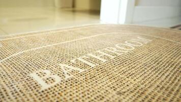 A bathroom mat placed on a clean tiled floor, creating a welcoming and cozy environment in the room video