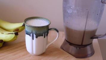 Morning Smoothie Preparation Using a Blender and a Mug for a Nutritious Start to Your Day video
