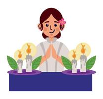 A woman praying with candles and flowers vector