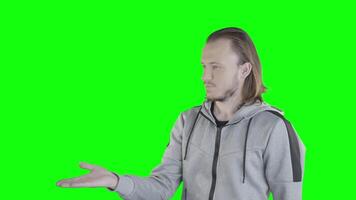 Man points to something on the green screen video