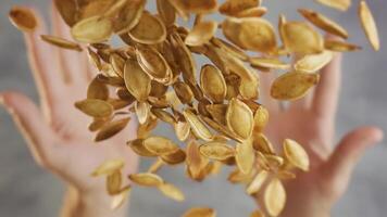 Throwing pumpkin seeds in slow motion video