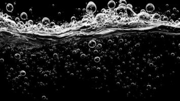 Soda water bubbles splashing underwater against black background. photo