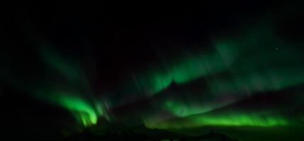 Aurora australis or Aurora borealis or Green northern lights sky above mountains. photo